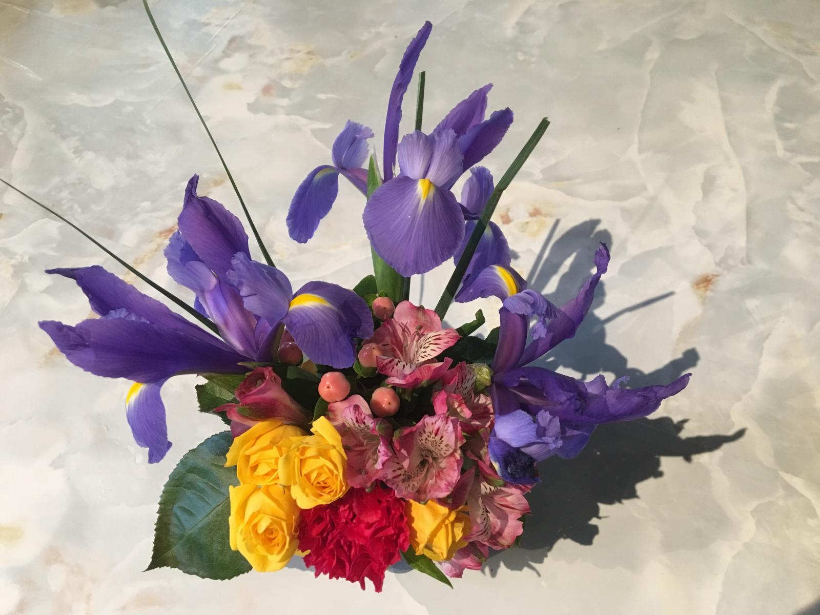 A bouquet of purple, yellow, and red flowers