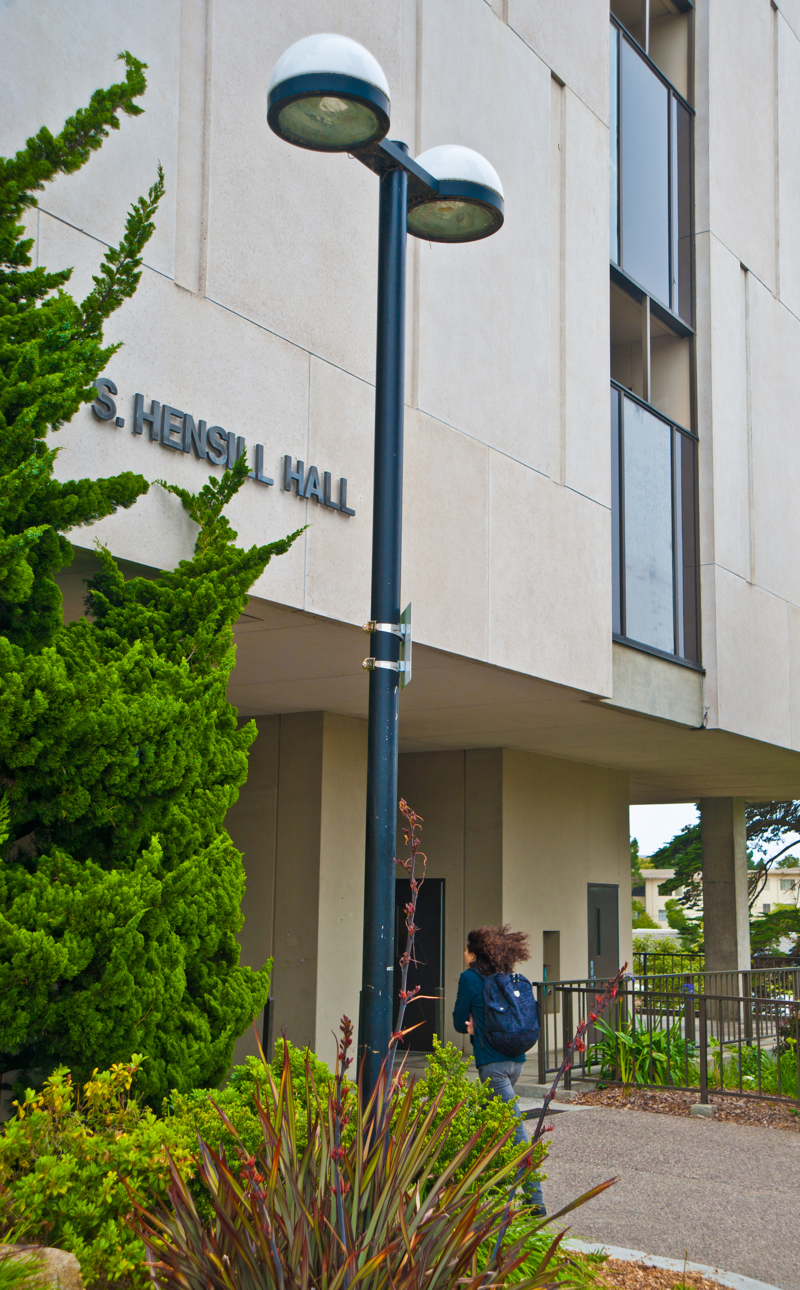 An SFSU student walking into Hensill Hall